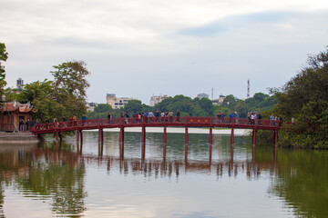 Hanoi, Vietnam - October 21, 2019 : Hanoi red bridge. The wooden red painted bridge over the Hoan Kiem Lake connects the shore and the Jade Island on which Ngoc Son Temple stands.