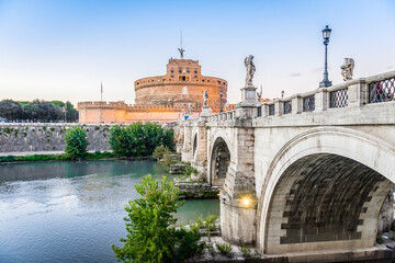 The bridge over the Tiber river and Castel Sant Angelo in Rome in the evening