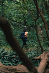 beautiful young woman walking in the forest wearing casual clothes