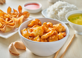 chinese food with orange chicken, crab rangoon and fortune cookie