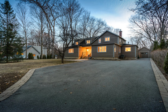 Real estate photography - exterior of single family house during twilight hours in Montreal's suburb