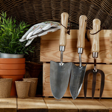 Gardening tools on a wooden table before fall cleanup