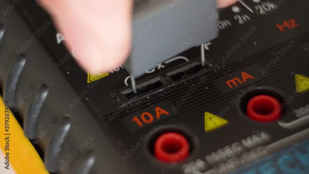 Poster measuring values of capacitor with multimeter.