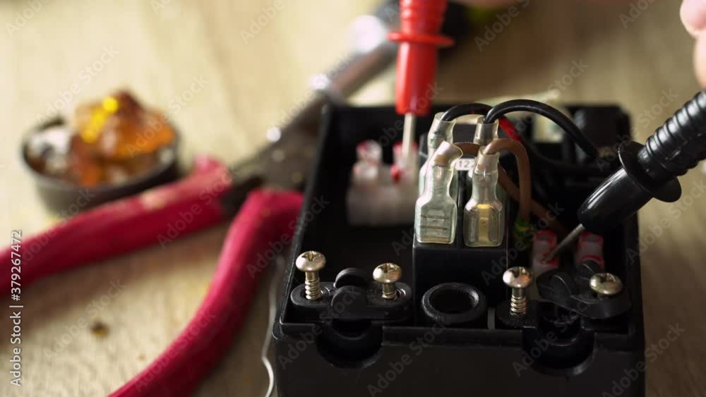 Poster measuring voltage in electronic device with two probes.