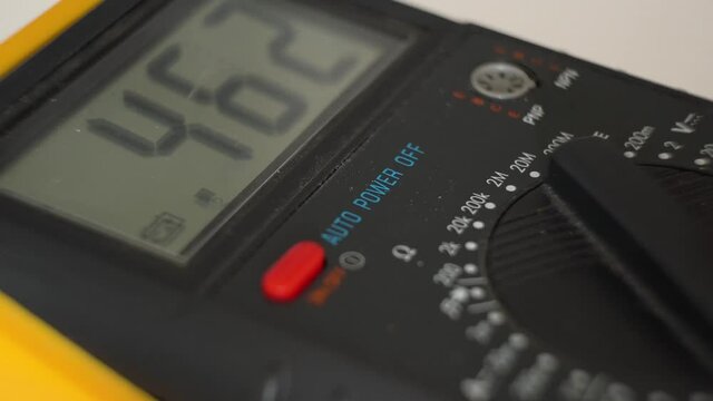 Numbers jumping up and down on electronic multimeter.