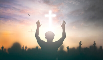 Worship concept: christian people Raise hand over cross on spiritual sky background