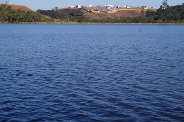 blue lake with a horizon from a forest park
