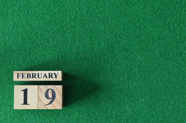 February 19, number cube on snooker table, sport background.