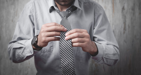 Businessman fixing his tie. Fashion, Lifestyle