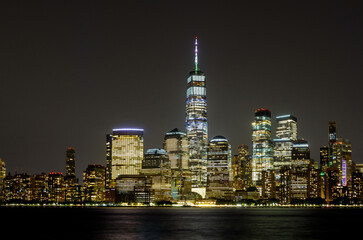 New York City Manhattan skyline panorama at night over Hudson river with reflections viewed from New Jersey