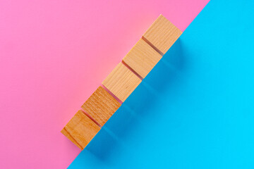 Top view photo of wooden blocks on pink and blue