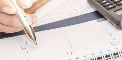 Financial data analyzing. Counting on calculator. Hand with pen on calculator