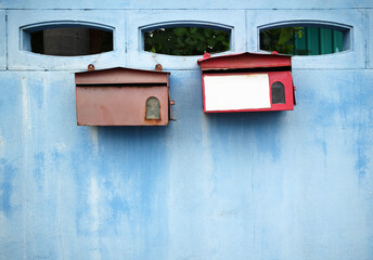 old mailbox on blue wall with space for text or image

