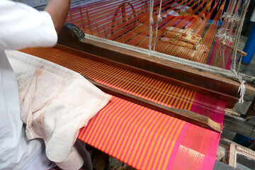 Weaver uses a Jacquard punched card loom