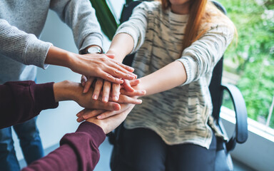 Fototapeta premium Closeup image of business team standing and joining their hands together in office