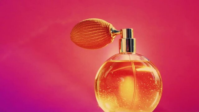 Golden fragrance bottle and shining light flares on pink background, glamorous perfume scent as holiday perfumery product for cosmetic and beauty brand, stock footage