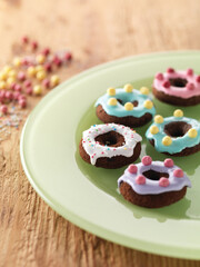Obraz na płótnie Canvas colorful icing donuts on plate