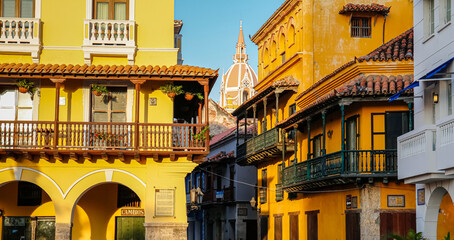 View to typical colorful buildings with church tower in the back, Cartagena, Unesco World Heritage