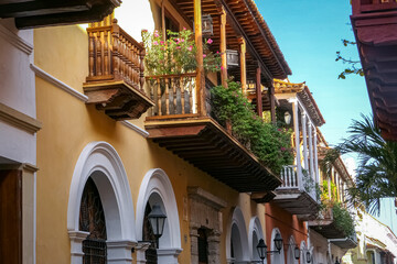 View to artful wooden balconies of historic houses in a narrow street in Cartagena, Colombia
