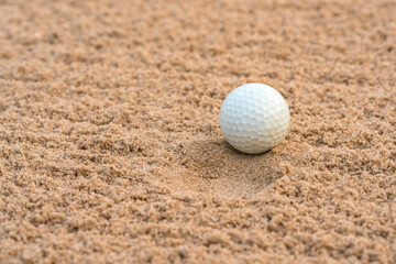 Golfer hit Golf ball on sand trap bunker at golf courses