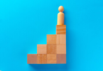 Top view of wooden toy blocks on blue