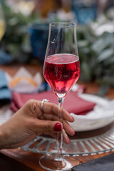 Vertical shot of woman holding glass with sparkling champagne in