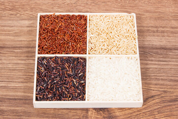 Heap of white, brown, red and black rice, healthy nutrition concept
