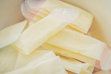 Above view of breast milk frozen in storage bags for newborn baby on white background....