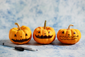 Halloween pumpkins with painted face on blue color background