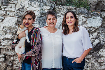 portrait of hispanic mother with her adult daughters in Mexico