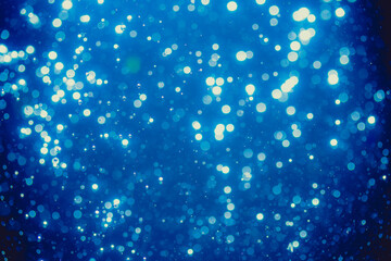 Abstract blue defocused bokeh of lights in dark
