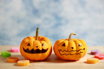 Halloween pumpkins with painted face on blue color background