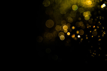 Gold bokeh of water fly and lights on black background