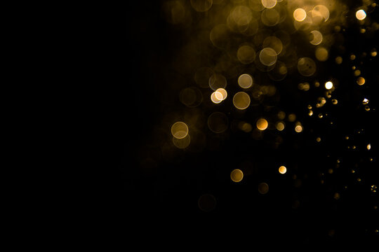 Gold bokeh of water fly and lights on black background
