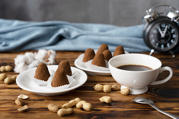 Morning breakfast consisting of homemade handmade chocolate candies with peanuts on white plates...