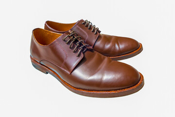 Man brown shoes isolated on white background. Leather footwear with cut out.