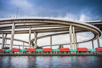 The beautiful view floodgate of Bhumibol Bridge during the evening time in Bangkok at Thailand, known as the Industrial Ring Road Bridge over the Chao Phraya River.