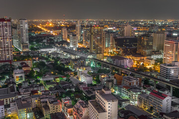 Fototapeta na wymiar Aerial view of the modern buildings and skyscrapers at night of Baiyoke Tower, Ratchaprarop Road in the Ratchathewi district of Bangkok City, Thailand.
