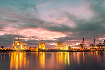 Harbor with anchored ship. Container cargo freight ship with working crane bridge at a shipyard in for logistic transportation import and export at Asia haven port background, Samutprakarn, Thailand.