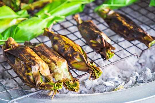 Delicious popular traditional Thai Asian style dessert food. Sticky rice toast with taro and banana leaf in Bang Nam Phueng Floating Market, Samut Prakan province, Thailand.