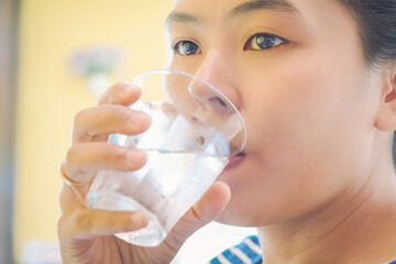 Woman drinking water in the morning. 