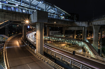 Fototapeta na wymiar Overpass of the light trails with Bangkok city background at night. Beautiful curves. Selective focus.