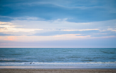 Beautiful golden sunset with blue sky over the horizon on the beach background, Thailand. Tropical twilight colorful sunrise from the landscape sea. Summer ocean vacation concept.