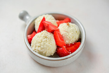Vanilla ice cream with fresh organic strawberry and coconut flakes. Isolated on white background.