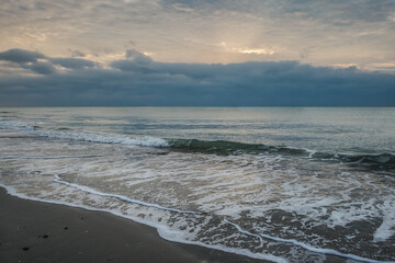 Beautiful golden sunset with blue sky over the horizon on the beach, Thailand. Tropical colorful sunrise from the sea.
