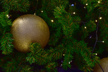 Closeup of Christmas Ball on Christmas Tree with bokeh beautiful background for design and decoration, new year concept, selective focus.