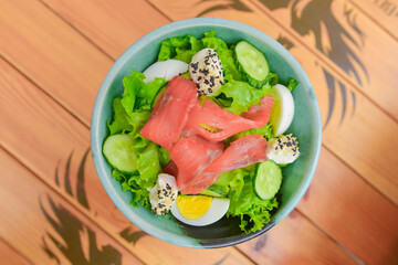 Rice and veggies salad. Delicious healthy vegetable salad with salmon fish. Healthy eating concept, tasty dinner.