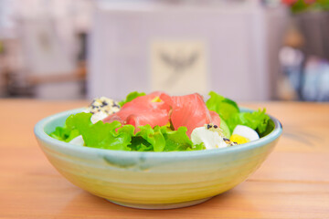 Rice and veggies salad. Delicious healthy vegetable salad with salmon fish. Healthy eating concept, tasty dinner.