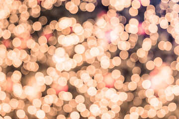 Defocused abstract bokeh circular reflection of Merry Christmas light on gold background. Eve party winter. Happy new year concept.