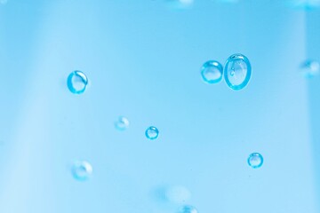 drops of water,Blue alcohol gel for washing hands to prevent the Coronavirus protection (Covid-19). There are beautiful bubbles in the gel.Blue background